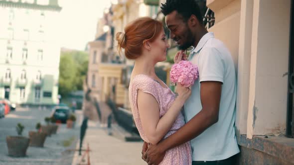 Young Couple in Love Standing and Tenderly Cuddling on Streets of European Cities