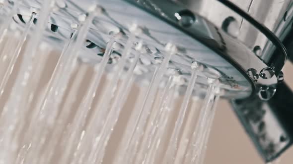 Close Up of Water Drops Flowing From Shower Head in Bathroom Slow Motion