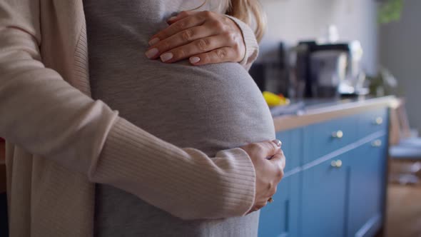 Close up of pregnant woman touching the belly. Shot with RED helium camera in 8K