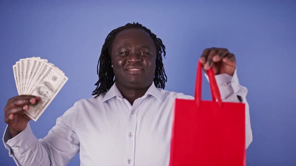 African Man Holding Red Shopping Bag and Money. Shopping Time
