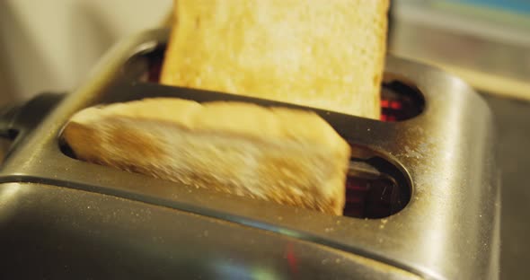 Slow motion shot of toast jumping out of an old toaster