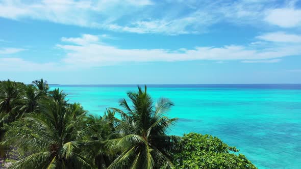 Aerial drone shot nature of relaxing coastline beach vacation by blue water with white sandy backgro