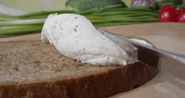 Creamy Textured Paste With Dill Is Spreading On The Toast Of Bread With Butter Knife