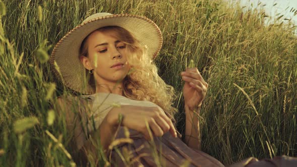 Girl with a Spike in Her Hands Lies in the Grass