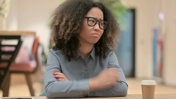 Young African Woman Feeling Worried While Sitting in Office