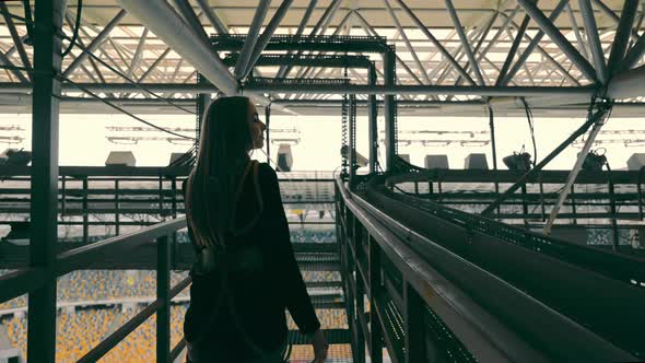 Silhouette of a Woman Industrial Climber Moving on Metal Structures on Top of a Building