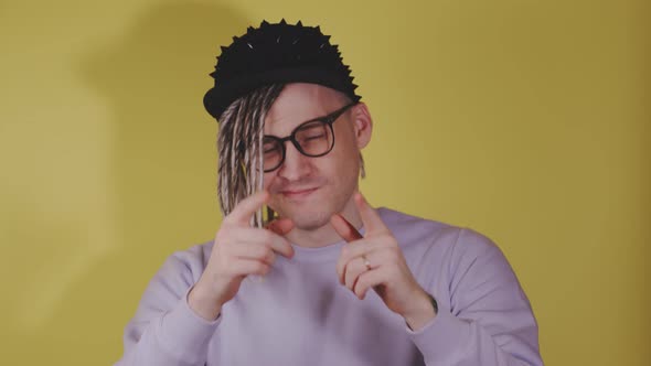 Young Handsome Man in Black Cap Glasses Showing Thumbs Up Looking at Camera