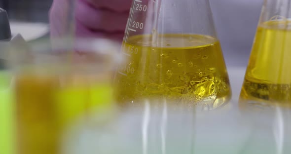 Scientist Chemist Pouring Liquid Into Flask with Motor Oil in Laboratory Closeup  Movie Slow Motion