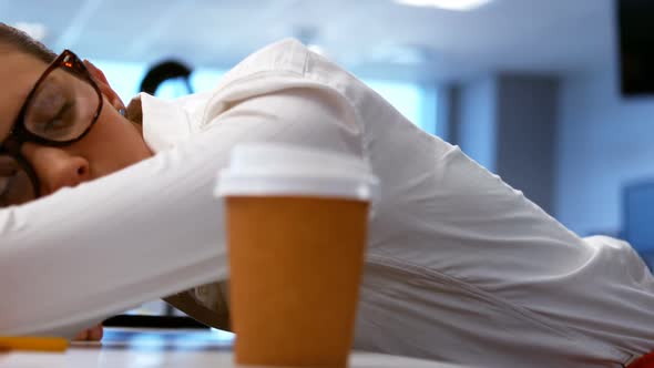 Tired graphic designer sleeping on his desk