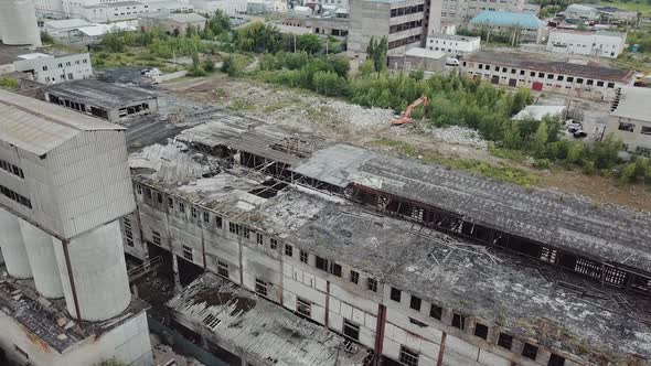 Flying over abandoned industrial factory buildings in very dilapidated condition.