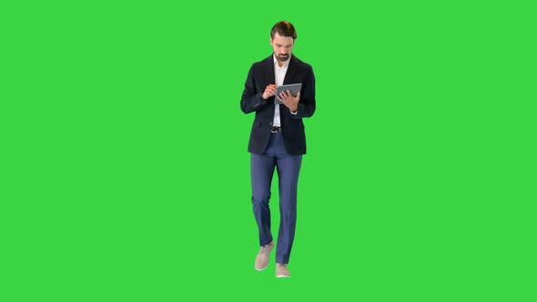 Young Businessman Working with Digital Tablet on a Green Screen Chroma Key