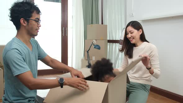 Happy asian women LGBT lesbian couple holding boxes entering new modern house