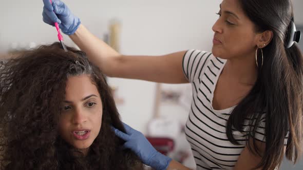 Video of two hairdresser coloring a woman's hair at home. Shot with RED helium camera in 8K