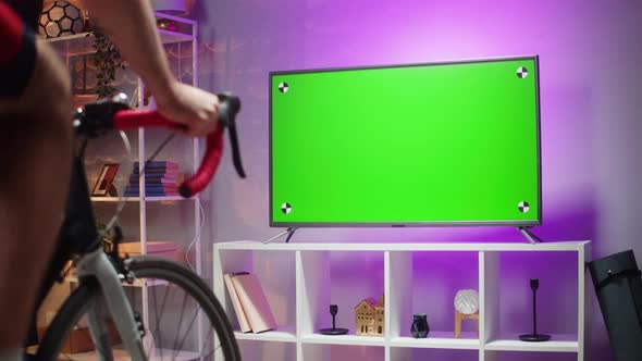 Sportsman Riding Bicycle and Watching Tv Green Screen Home Gym