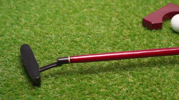 Mini Golf Game Equipment on Grass Background Close Up