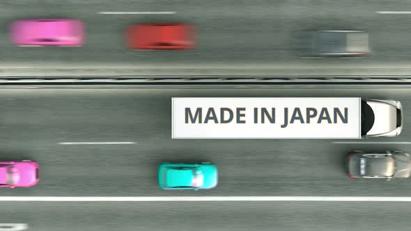 Trailer Trucks with MADE IN JAPAN Text Driving Along the Road