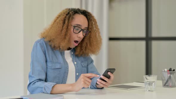 Upset African Woman Reacting To Loss on Smartphone