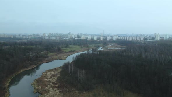 The river among the city park. Late autumn, cloudy.