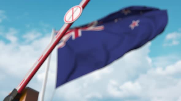 Closing Barrier with STOP CORONAVIRUS Sign at Flag of New Zealand