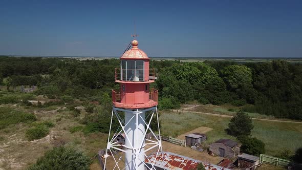 Beautiful aerial view of white painted steel lighthouse with red top located in Pape, Latvia at Balt