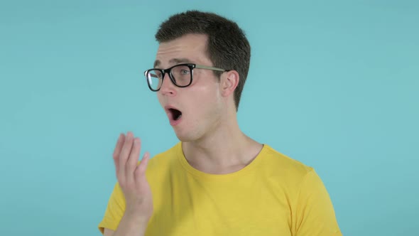 Man Yawning and Stretching Body, Blue Background