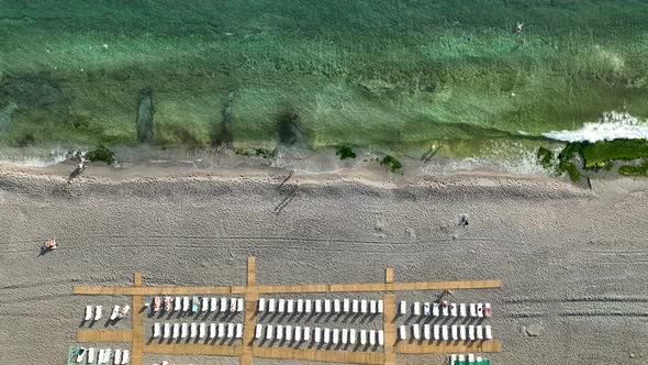 Empty sun loungers on the beach aerial view 4 K Turkey Alanya