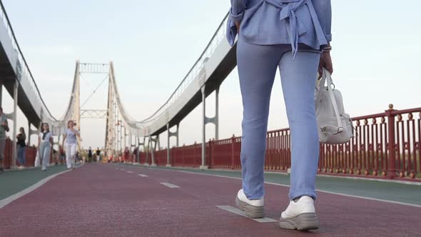 Business Girl Walking on a Foot Bridge
