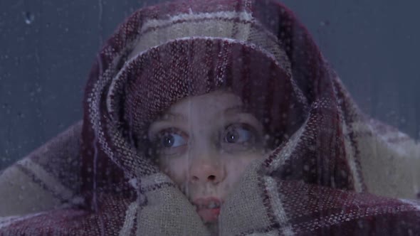 Cute Little Girl Covered With Plaid Frightened by Thunderstorm and Lightning