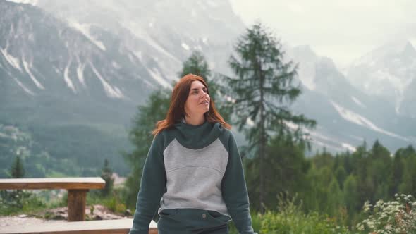 Slow Motion Shot of Happy Young Woman Walks in the Dolomites Mountains Northern Italy in the Summer