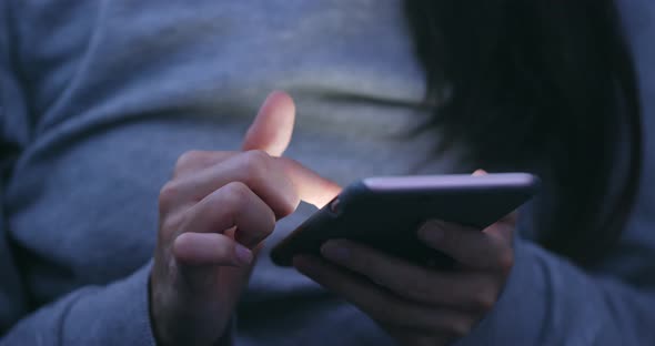 Woman using smart phone in the evening