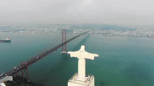 Ponte De Abril Lisbon Bridge Over River and Jesus Monument