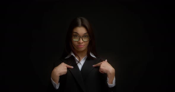 Portrait of a Surprised Businesswoman Pointing at Herself with Her Index Fingers