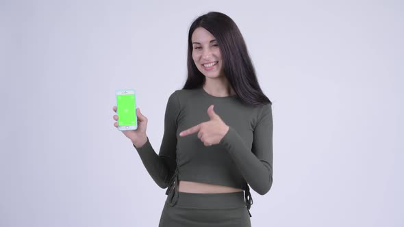 Happy Young Beautiful Woman Showing Phone and Giving Thumbs Up