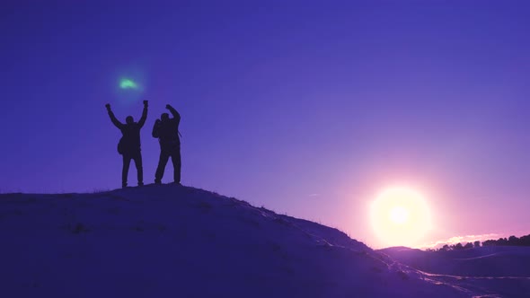 Men Tourists with Backpacks Are in Winter on Hill in Rays of Bright Sun. Climbers on Top of a Snowy