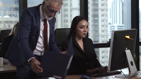 Senior Manager Gives Advice to Young Woman Worker