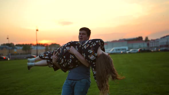 Happy Couple in Love Funny Whirling in Summer Evening Sunset Park