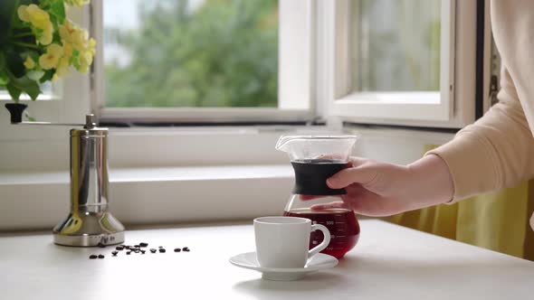 Unrecognisable Woman Pouring a Hot Coffee From Glass Coffee Maker