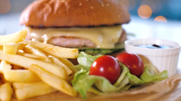 Crispy French Fries with Burger on Wooden Board