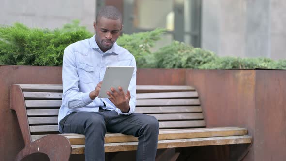 Professional Young African Man Using Tablet Outdoor