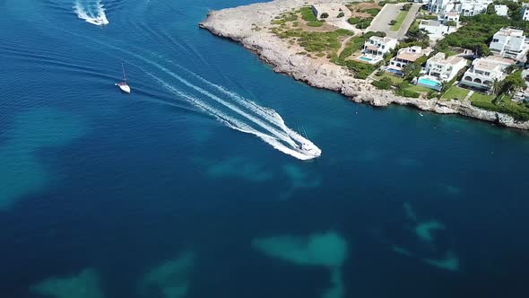 Aerial: The bay of Cala D'Or resort town in Mallorca, Spain