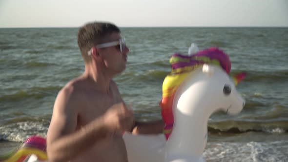 Funny Tourist Man is Resting on the Sea Beach