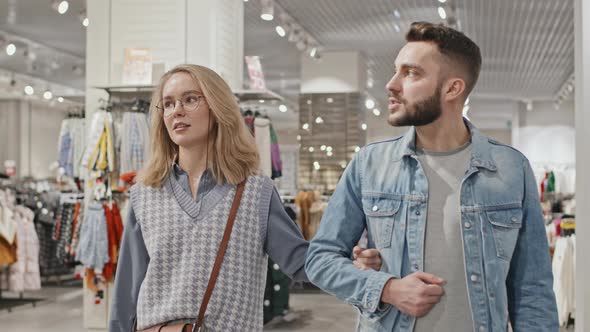 Stylish Young Couple Shopping In Clothing Store