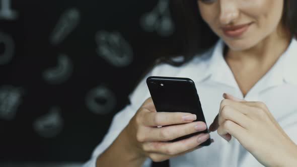 Close-up of Female Holding Phone and Showing Surprise Actions with Arm