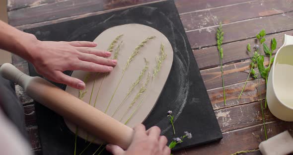 The Master Leaves the Imprint of the Plants on the Clay Board in Pottery Studio
