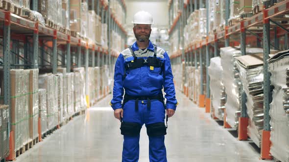 Male Storehouse Worker Wearing Liftassist Device and a Hardhat