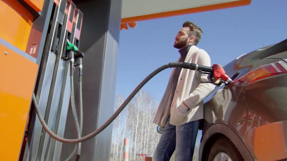 Driver Waiting at Gas Pump