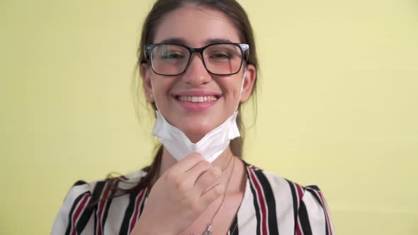 Young Woman Take Off Face Mask Removing From Face