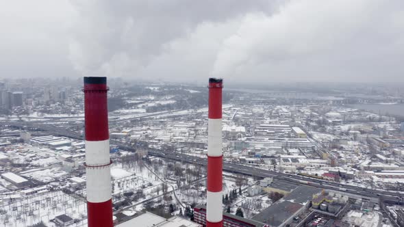 Winter View of a Big Modern Industrial City with Two Tall and Heavily Smoking Factory Pipes alt
