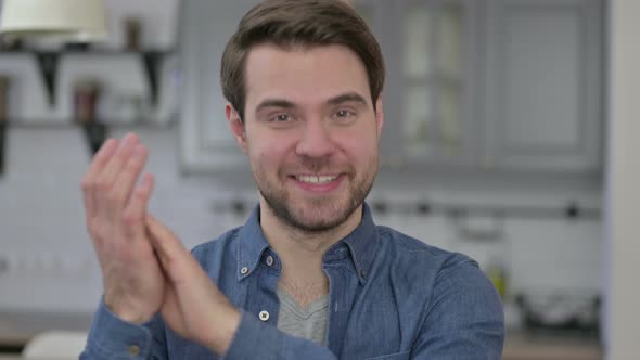 Portrait of Beard Young Man Smiling and Clapping