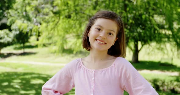 Smiling girl standing in the park